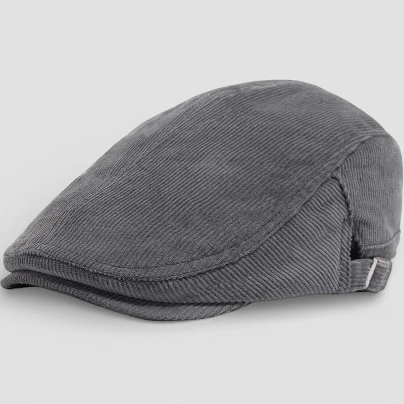 Gray corduroy flat cap with structured curved brim and stitching details