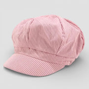 Soft pink corduroy newsboy cap with ribbed texture and curved brim