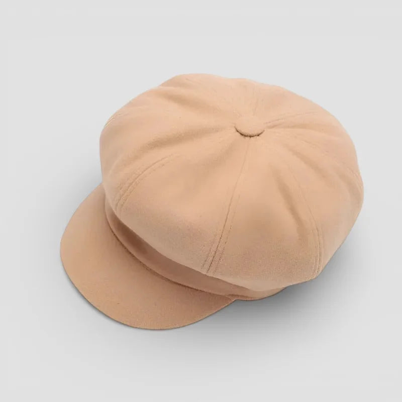 Beige leather newsboy cap with 8-panel design and curved brim