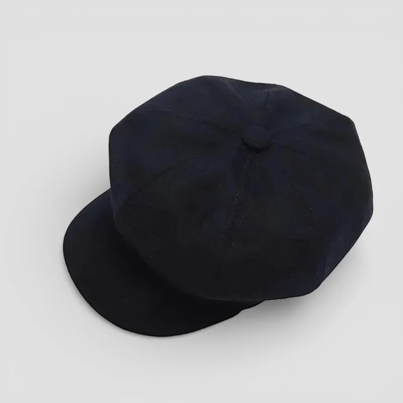 Black octagonal cotton newsboy hat with flat brim and subtle stitching
