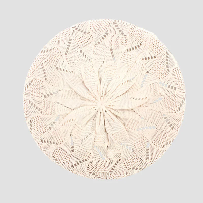 Cream-colored knitted beret.