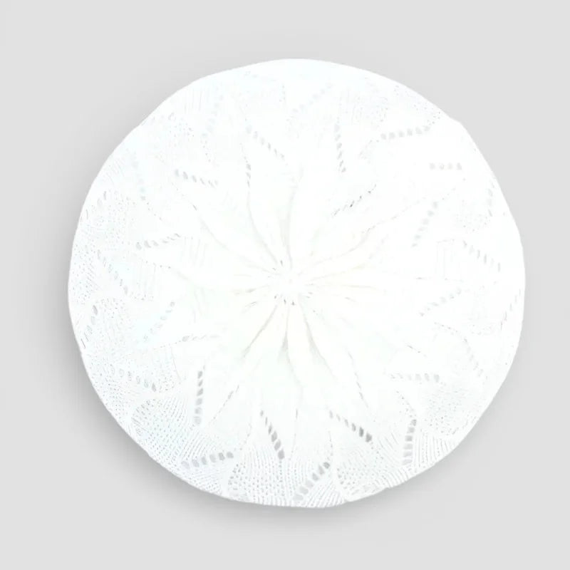 White circular knitted cushion with lace-like Crochet Beret Pattern