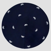Dark blue circular kippah with white embroidered bow patterns