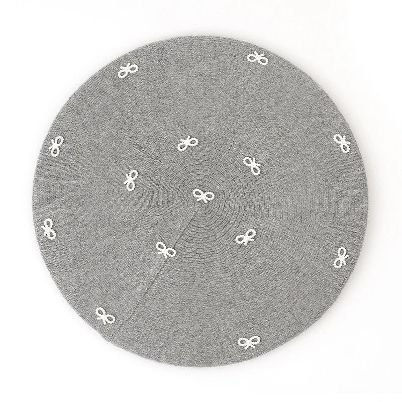 Gray beret with white bow accents.