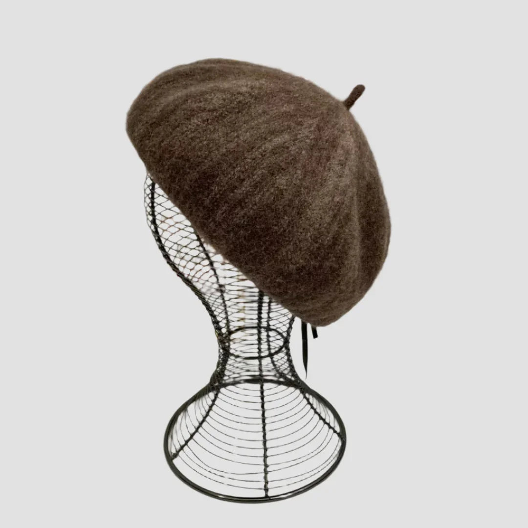 Brown wool beret on wire mannequin head.