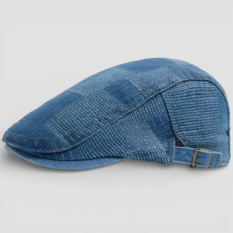 Blue denim flat cap with woven texture and adjustable buckle strap
