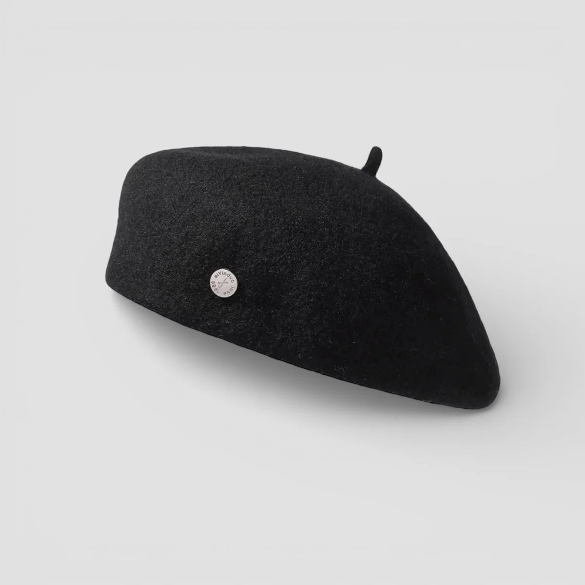 Black felted wool beret with silver emblem and tassel