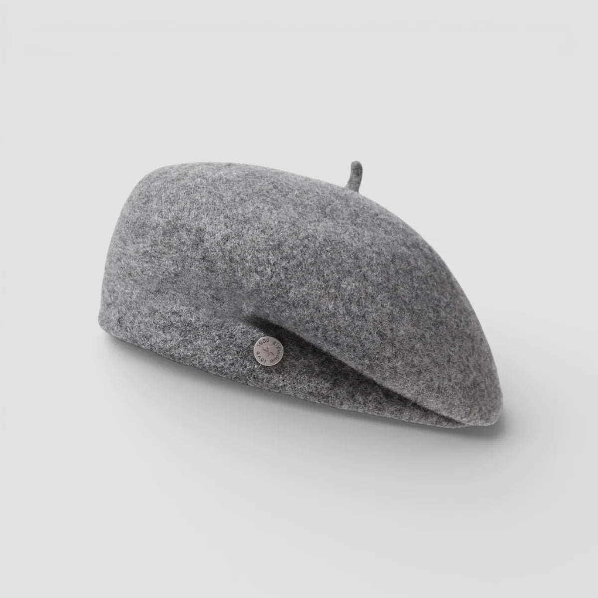Soft medium-gray felted wool beret with textured surface and metallic button