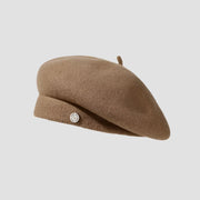 Tan wool beret with button.