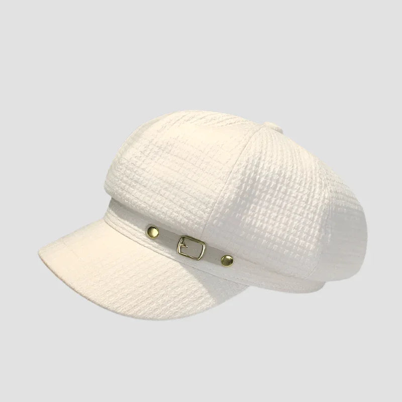 White textured newsboy cap with buckle.
