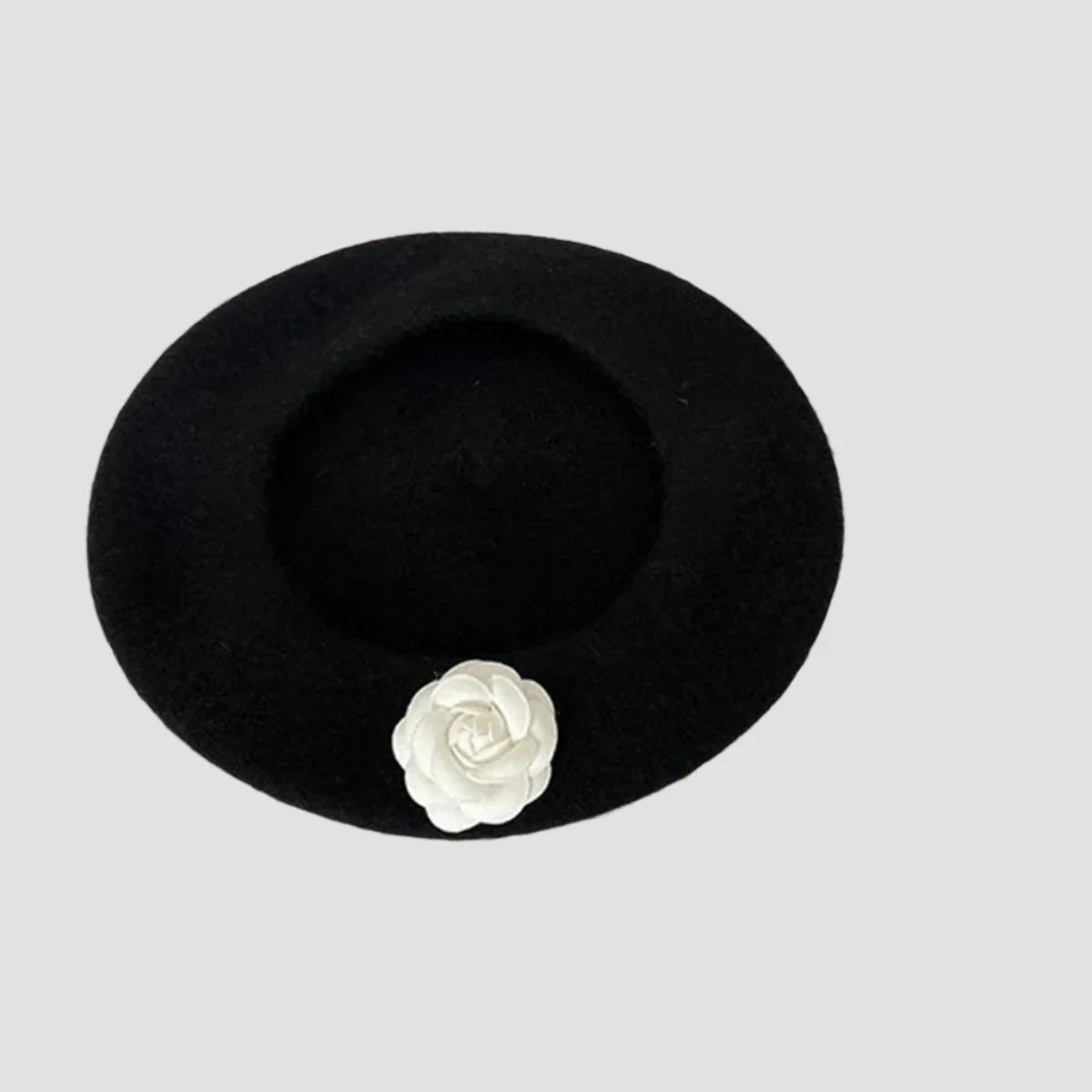 Black beret with white flower.