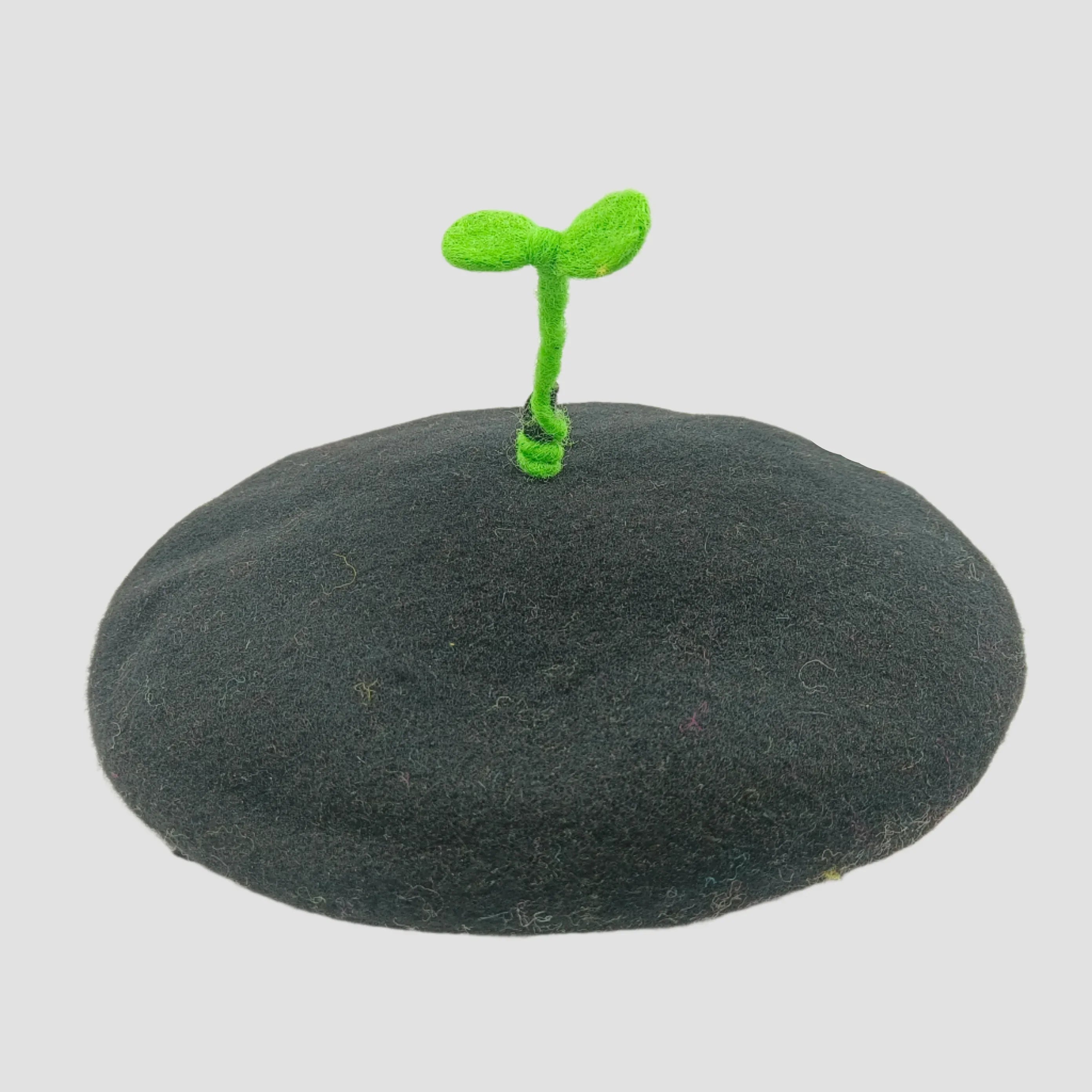 Black beret with green sprout.