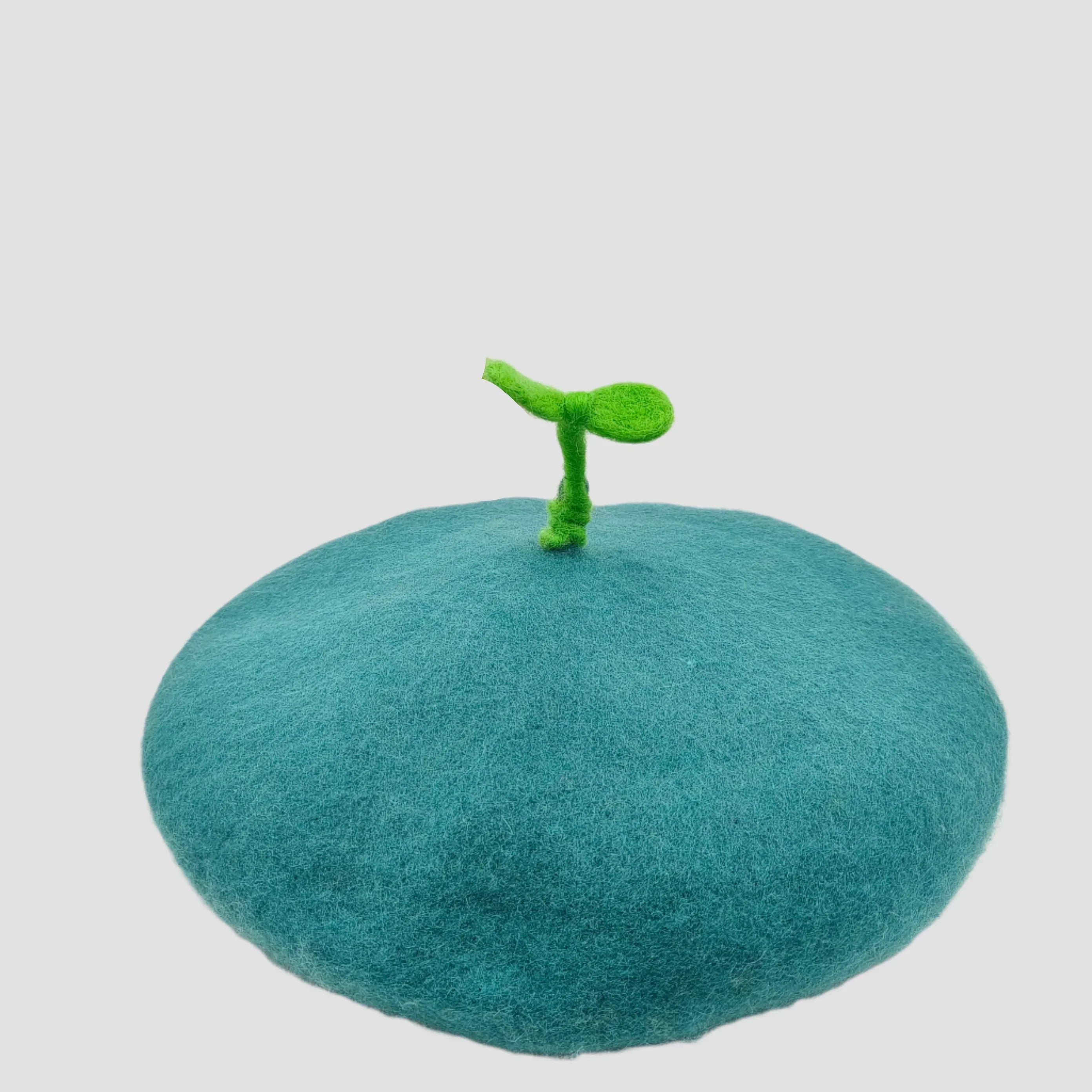 Teal beret with green sprout.