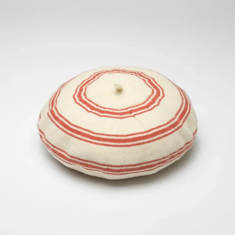 Striped beret with a top knot.