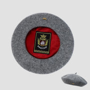 Gray beret with red interior and Breiter logo on a light gray background