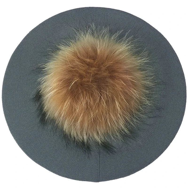 Gray knitted beret with fur pompom.
