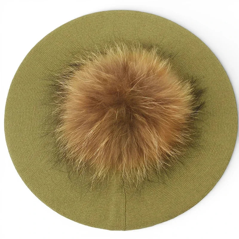 Olive green French beret with fluffy tan fur pom-pom on top