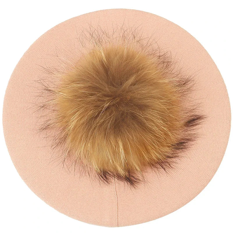 Peach-colored beret with a fluffy pompom.