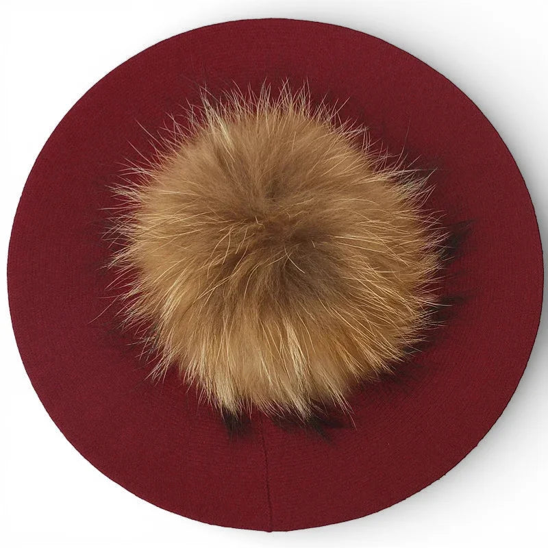French beret with pom pom features plush golden-brown fur center on burgundy wool