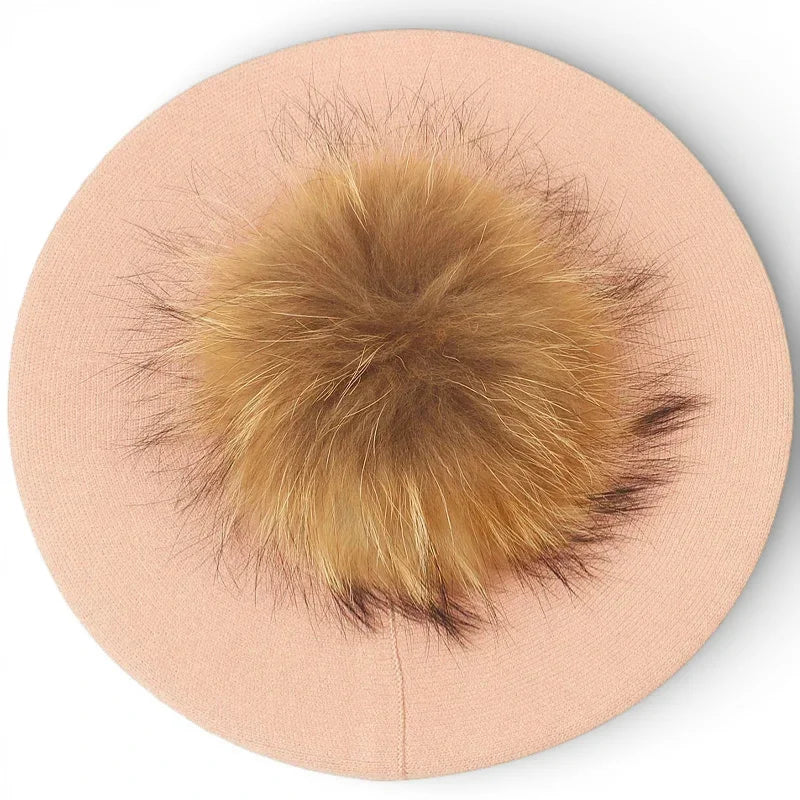 Soft blush pink French beret with fluffy golden-brown fox fur pom-pom