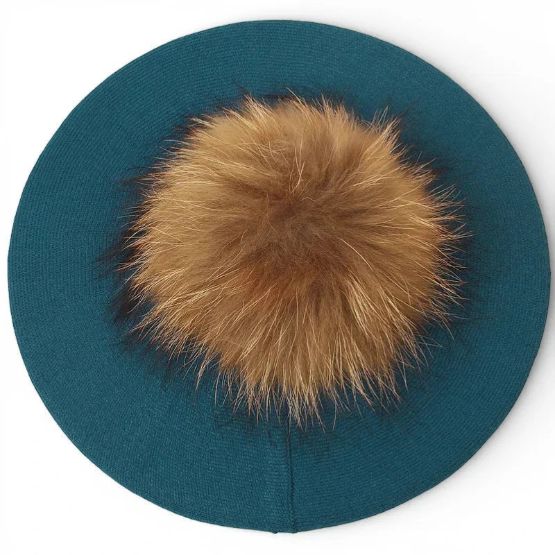 Teal knit French beret with fluffy tan fur pom-pom