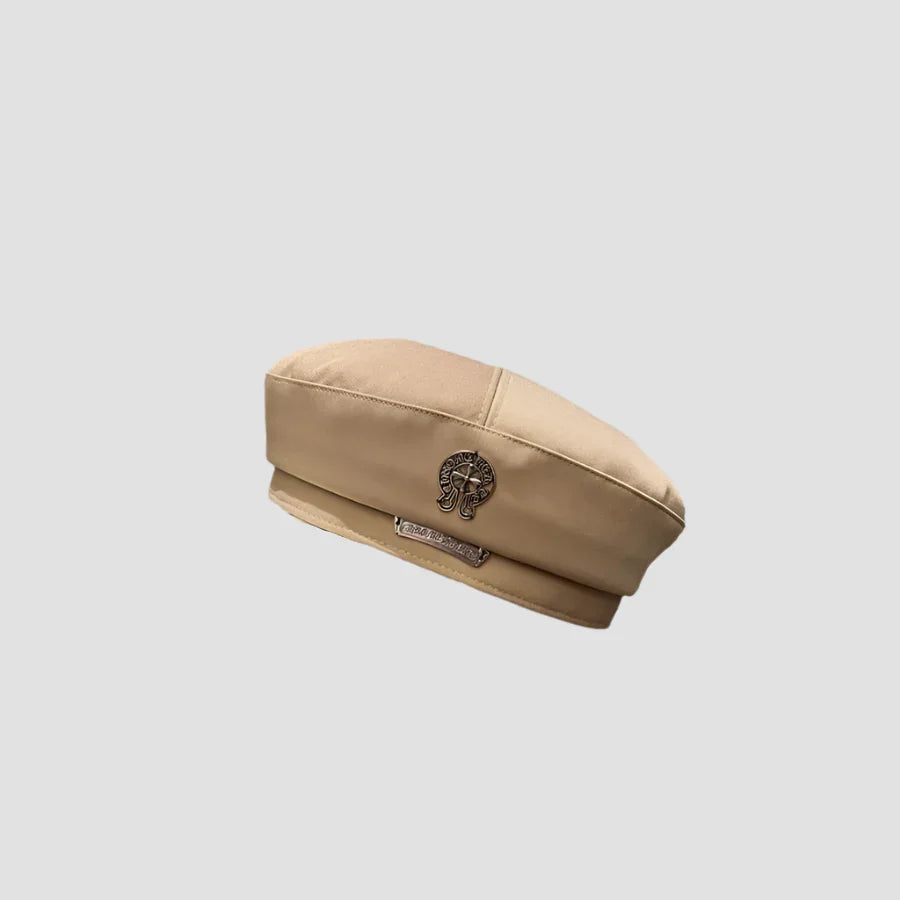 Beige beret with metal embellishments.