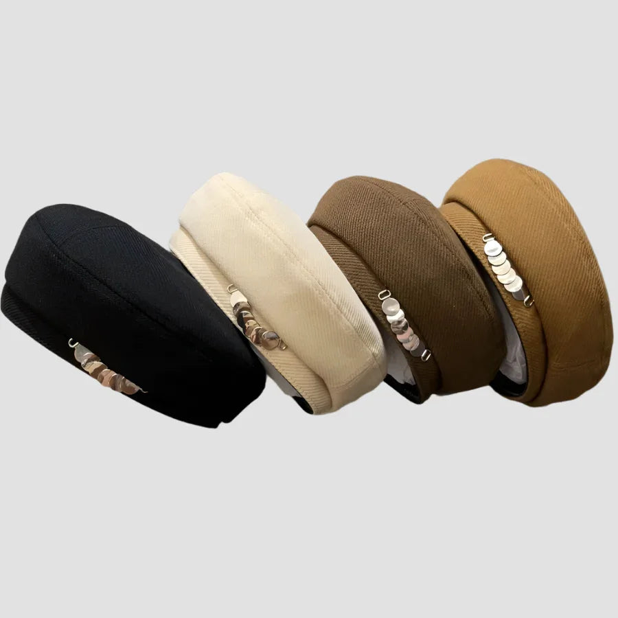 Four beret hats in different colors.