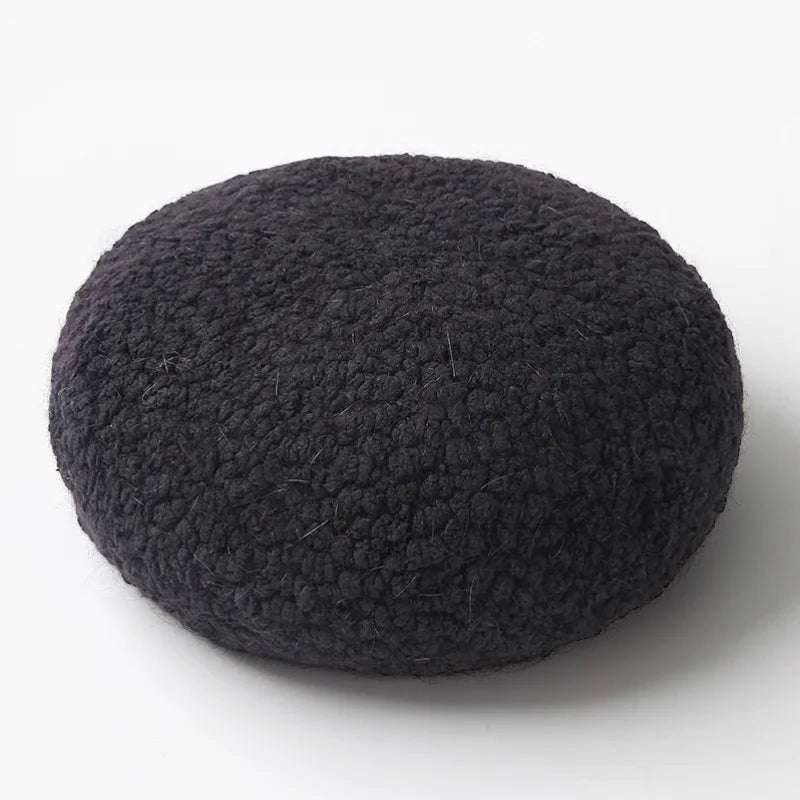 Black fuzzy round fur beret with textured surface