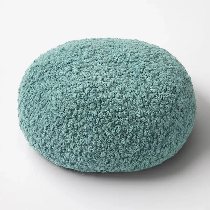 Round plush teal Fur Beret cushion with soft textured surface
