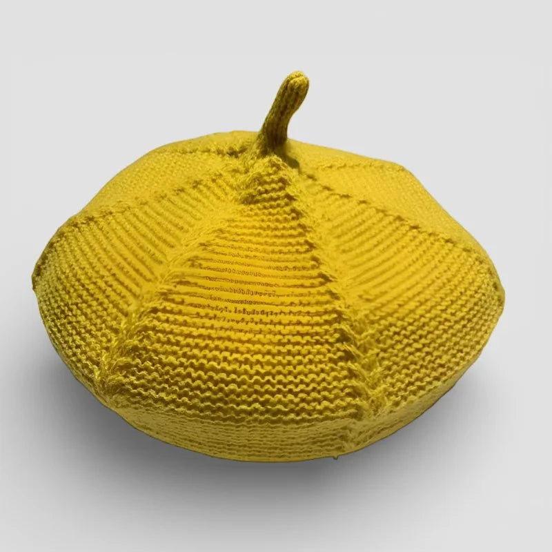 Vibrant yellow knitted pumpkin cushion in Genuine French Beret style