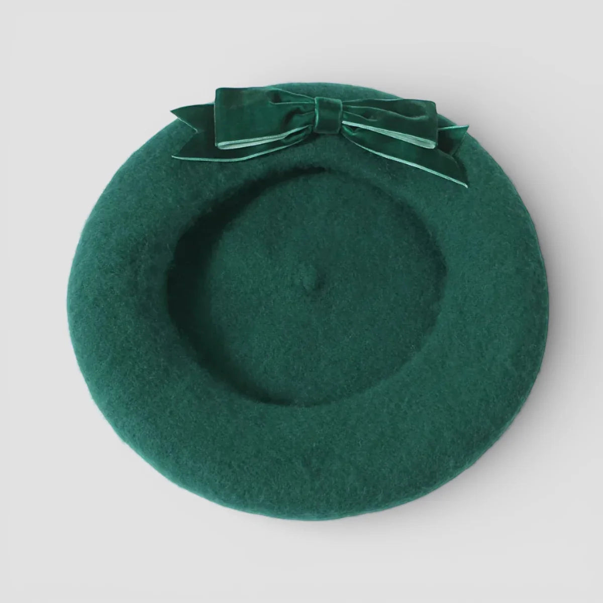 Green wool beret with deep green felt and matching velvet bow