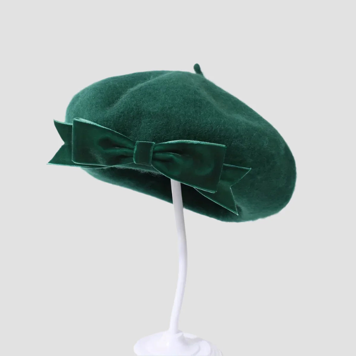 Emerald green beret with velvet bow.