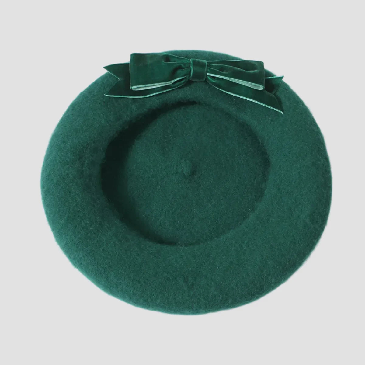 Green beret with velvet bow.