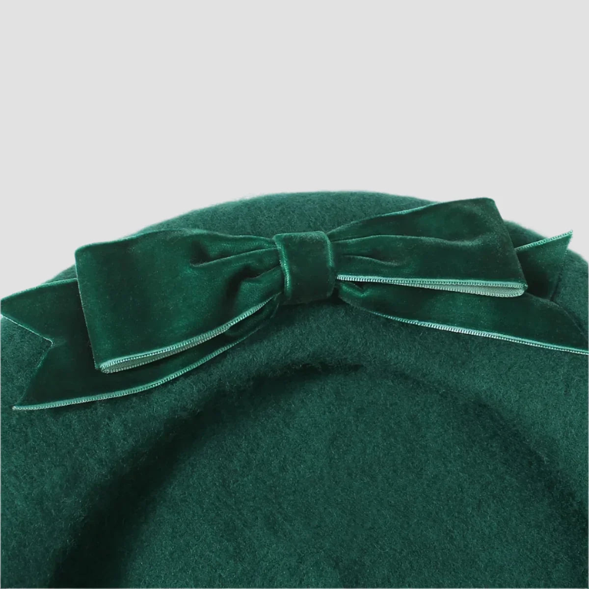 Green beret with velvet bow.