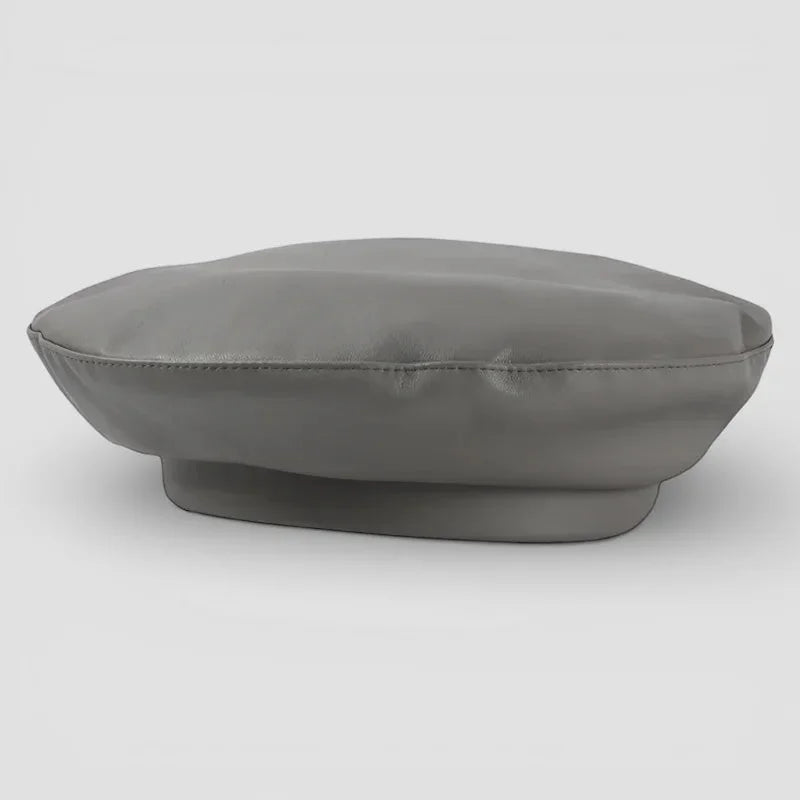 Grey leather beret with sleek matte finish, padded crown and subtle edge stitching
