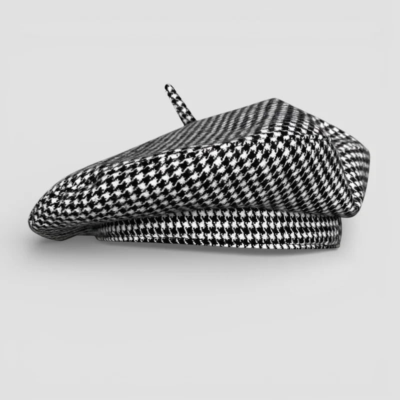 Houndstooth beret in black and white with decorative tassel on top