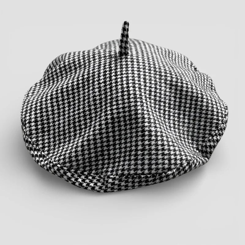 Classic black and white houndstooth beret with fabric tuft
