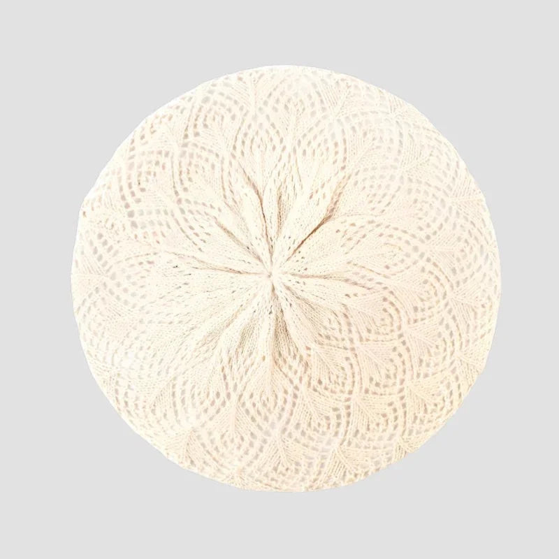 Cream-colored intricately patterned lace Knit Beret Pattern with symmetrical center design