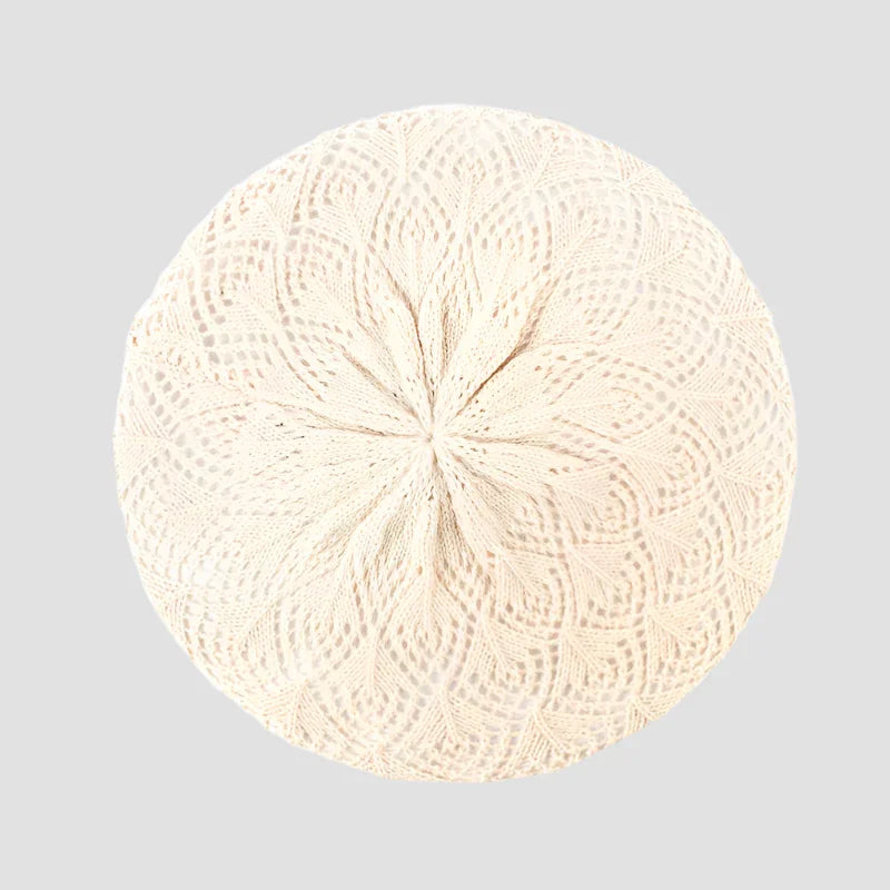 Cream-colored knitted beret.
