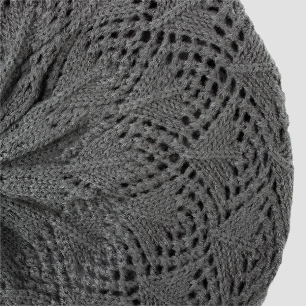 Gray knitted beret with openwork pattern.