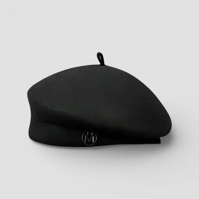 Knit wool beret in black with subtle sheen and metallic emblem