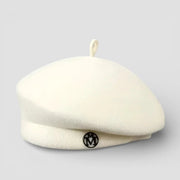 Knit wool beret in cream with black logo and top loop