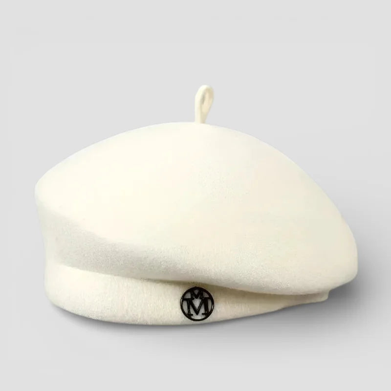 Knit wool beret in cream with black logo and top loop