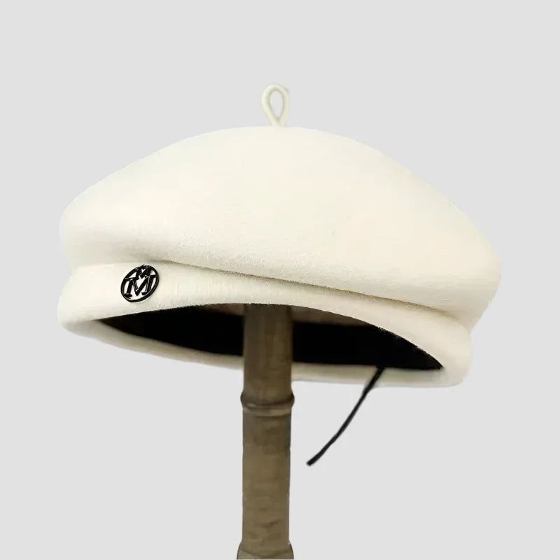 Cream-colored beret with black trim.