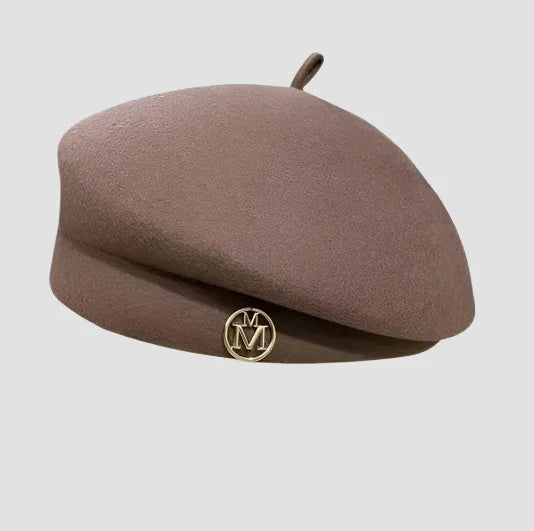 Taupe wool beret with gold emblem.