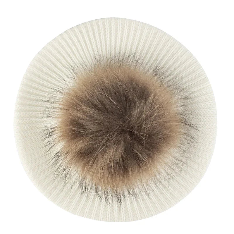 Cream-colored knit hat with fur pompom.