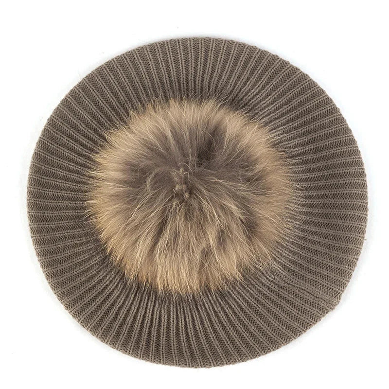 Knitted beret with fur pompom.