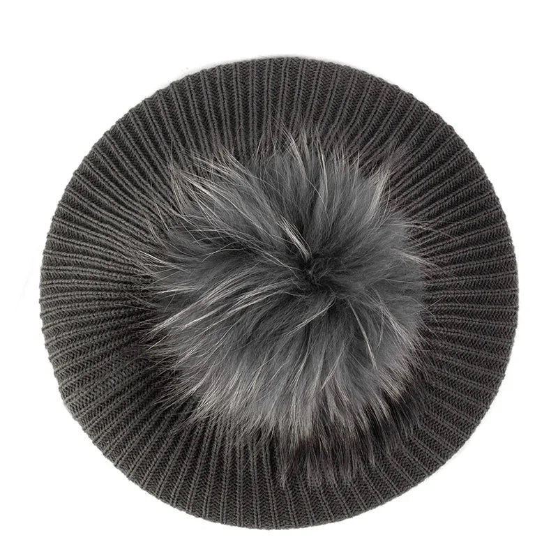 Gray knitted beret with fur pompom.