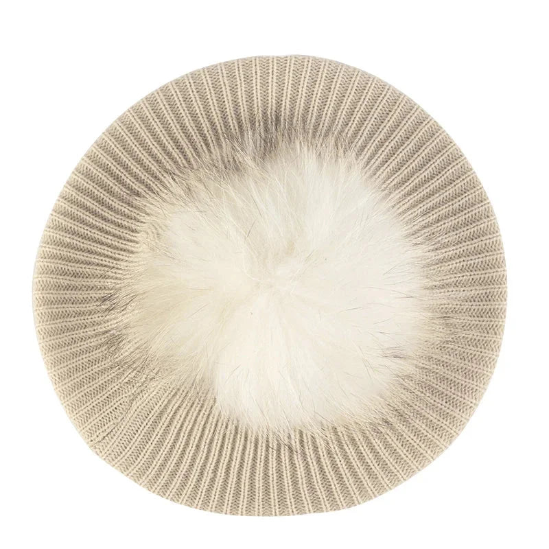 Knitted hat with fur pompom.