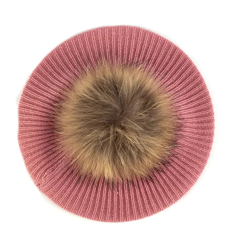 Pink knitted beret with fur pompom.